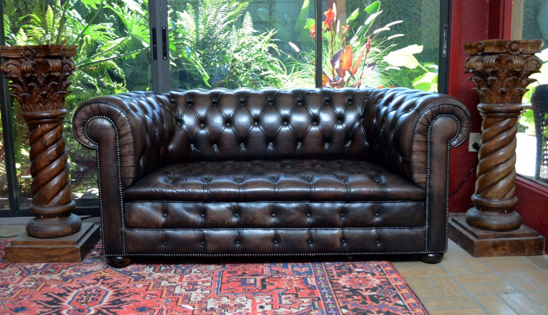 BROWN LEATHER CHESTERFIELD SOFA: BROWN LEATHER CHESTERFIELD SOFA: Tufted brown leather, on castors. No label. 31'' h. x 68'' x 34''.