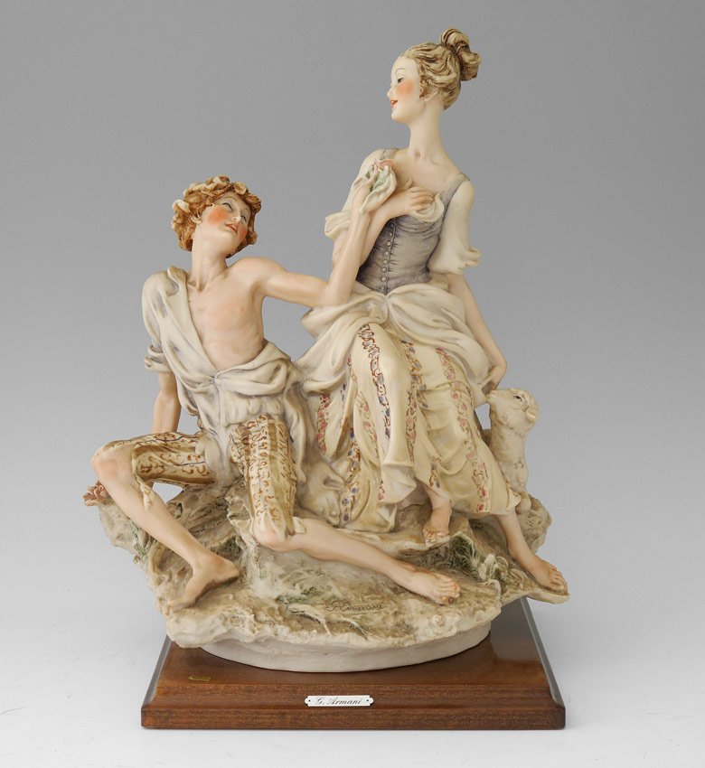 GIUSEPPE ARMANI FLORENCE SCULTURE d'ARTE FIGURINE: She: GIUSEPPE ARMANI FLORENCE SCULTURE d'ARTE FIGURINE: Shepherdess with sheep being courted with roses, possibly from the Capo di Monte collection, approx. 13 3/4''h. x 10 1/2'' x 8''.