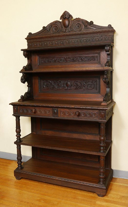 19TH C EUROPEAN CARVED WALNUT SIDEBOARD: 19TH C EUROPEAN CARVED WALNUT SIDEBOARD: 5 tier step-back sideboard with graduating shelves with molded edges. Crested top half featuring carved rosettes with scrolling acanthus leaf ornament over two