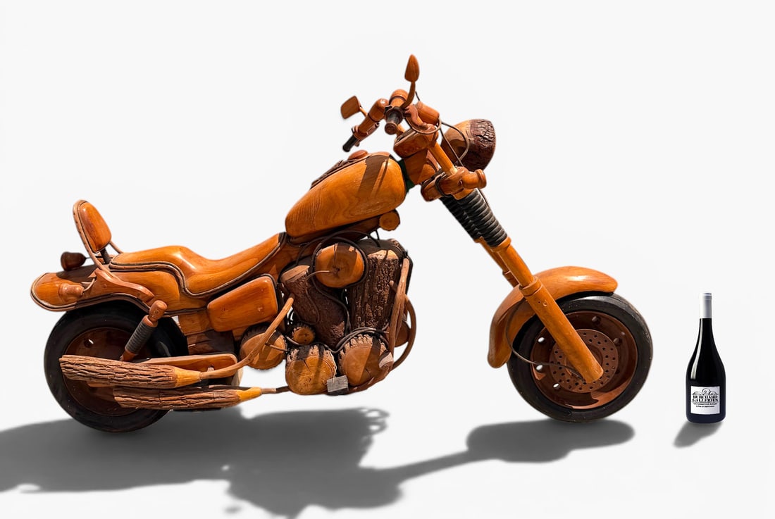 LIFE-SIZED WOODEN MOTORCYCLE SCULPTURE: LIFE-SIZED WOODEN MOTORCYCLE SCULPTURE: Life-sized Motorcycle made completely of wood. Very detailed example, having Brake lines, Lights, Gauges, Motor. Approx. 78" in length.