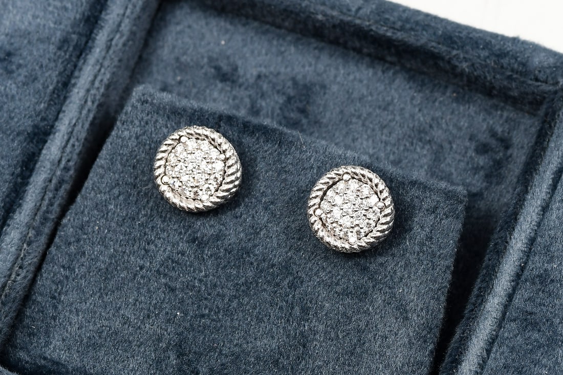 ROBERTO COIN 18K GOLD DIAMOND EAR STUDS: ROBERTO COIN 18K GOLD DIAMOND EAR STUDS: 18K white gold earrings contain 38 round brilliant cut diamonds. WEIGHT: .75 Ct. Approx. Rated VVS-VS in clarity and F-G in color. The diamonds are pave set.