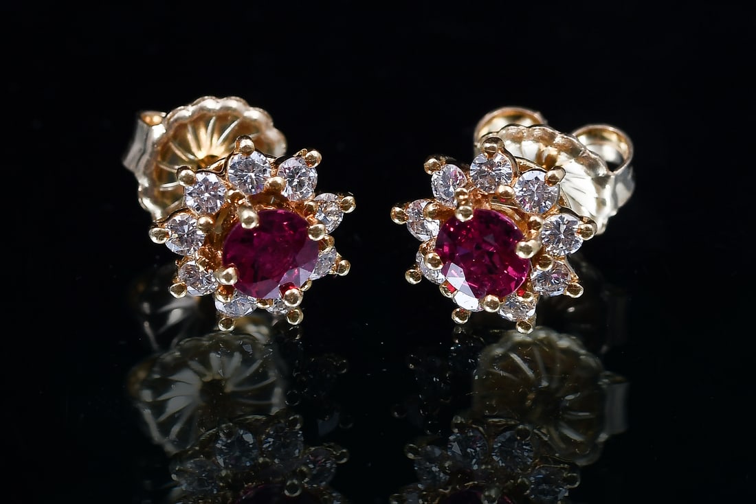 14K GOLD RUBY DIAMOND STUDS: 14K GOLD RUBY DIAMOND STUDS: 14K yellow gold ruby and diamond earrings contain 2 round mixed cut rubies measure approx. 4.35-4.60 mm. TOTAL RUBY WEIGHT: 1.10 Ct. Approx. Transparent, rated VS in Clari