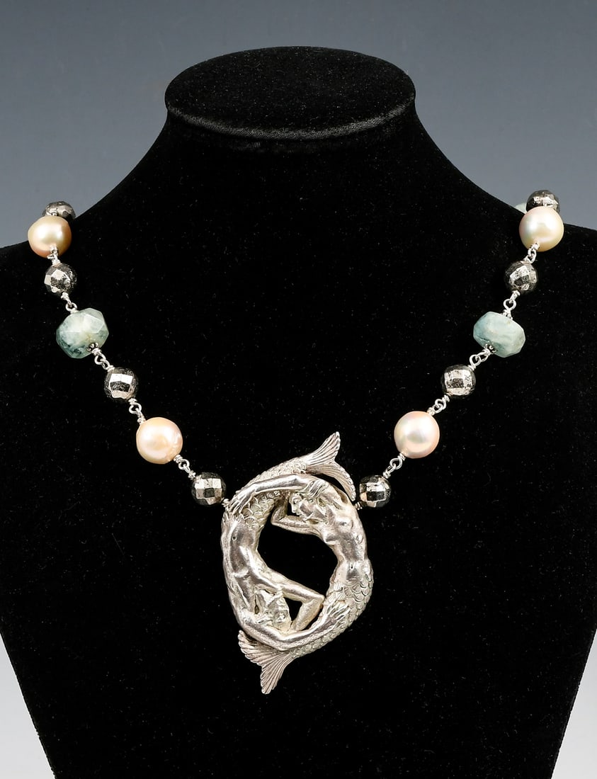 STERLING MERMAID NECKLACE: STERLING MERMAID NECKLACE: An intriguing hand crafted sterling necklace that features a pair of mermaids swimming about in a circle suspended from a beaded necklace that is comprised of baroque pearls