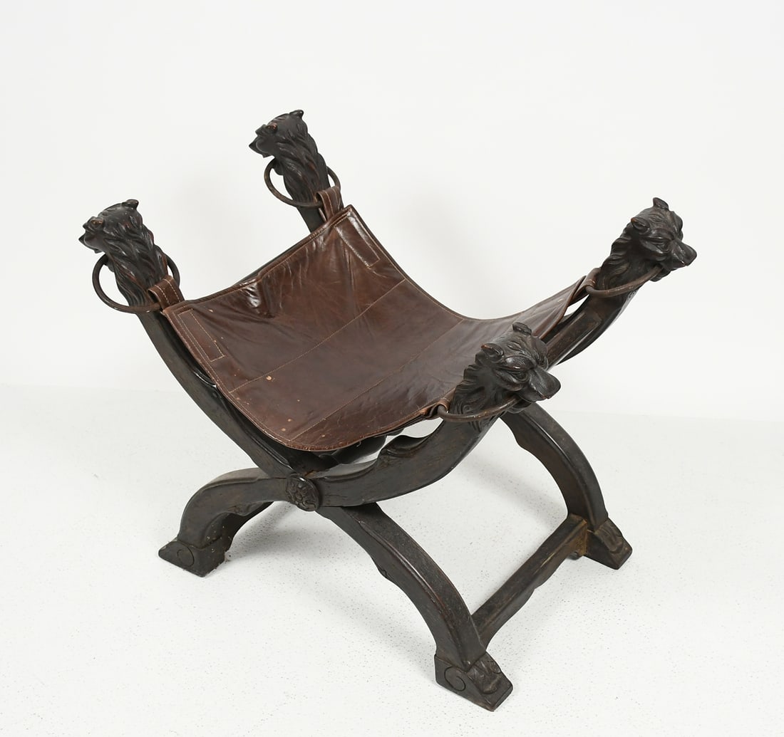 LATE 18TH-C. CARVED LION MOTIF HASSOCK STOOL: LATE 18TH-C. CARVED LION MOTIF HASSOCK STOOL: Carved stylized Lion form knuckles on an "X" form frame with floral medallions. Raised on foliate motif feet. Leather seat supported by Iron rings that ha