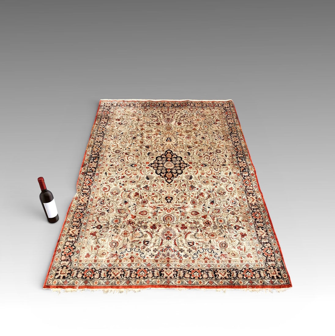 ESTATE ORIENTAL SILK FOLIATE MOTIF CARPET: ESTATE ORIENTAL SILK FOLIATE MOTIF CARPET: Silk carpet with dark blue center medallion surrounded by an intricate foliate- and berry-motif field. Dark blue border with additional foliate motifs and bu