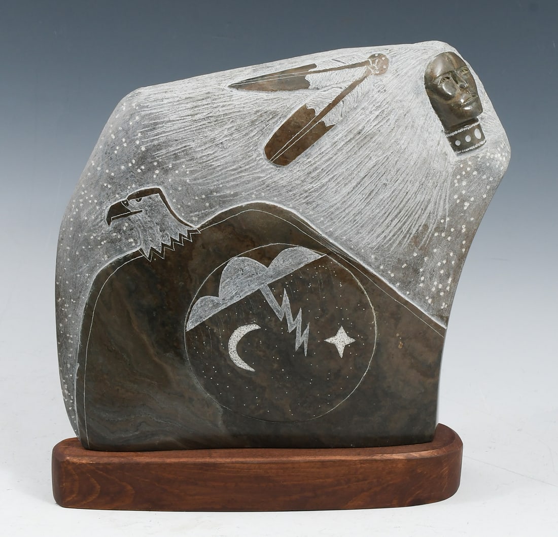 ORELAND JOE NATIVE AMERICAN STONE CARVING: JOE, Oreland, (Navajo, b. 1958): Native American Profile Portrait in Relief, Carved Stone, measures 10.25" in height, 11.5" in height overall with stone base, incised signature verso.