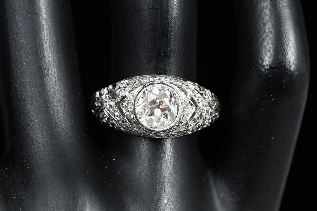 PLATINUM EDWARDIAN 1.68 CTW DIAMOND RING: PLATINUM EDWARDIAN 1.68 CTW DIAMOND RING: Platinum Edwardian revival ring contains one old European round cut diamond. Weight: 1.18 Ct. Rated VS2 in clarity and I in color. 32 round brilliant cut diam