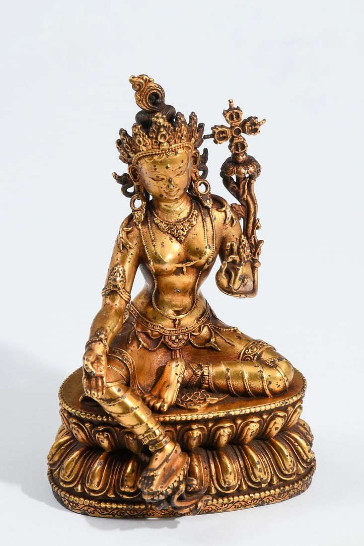 CHINESE GILT BRONZE GREEN TARA SEATED ON LOTUS: CHINESE GILT BRONZE GREEN TARA SEATED ON LOTUS BASE: Qing, possibly Ming Dynasty Gilt Bronze Tibetan Altar Statue of the Buddhist Bodhisattva Tara, in a seated with one leg extended and holding a Lotu