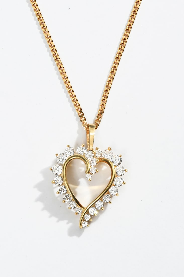 18K DIAMOND HEART PENDANT ON 22" CHAIN: 18K DIAMOND HEART PENDANT ON 22" CHAIN: This beautiful 18K yellow gold heart shaped pendant contains 24 round brilliant cut diamonds. Rated VS in clarity, G-H in color, and have a combined 1.50 CTW. D