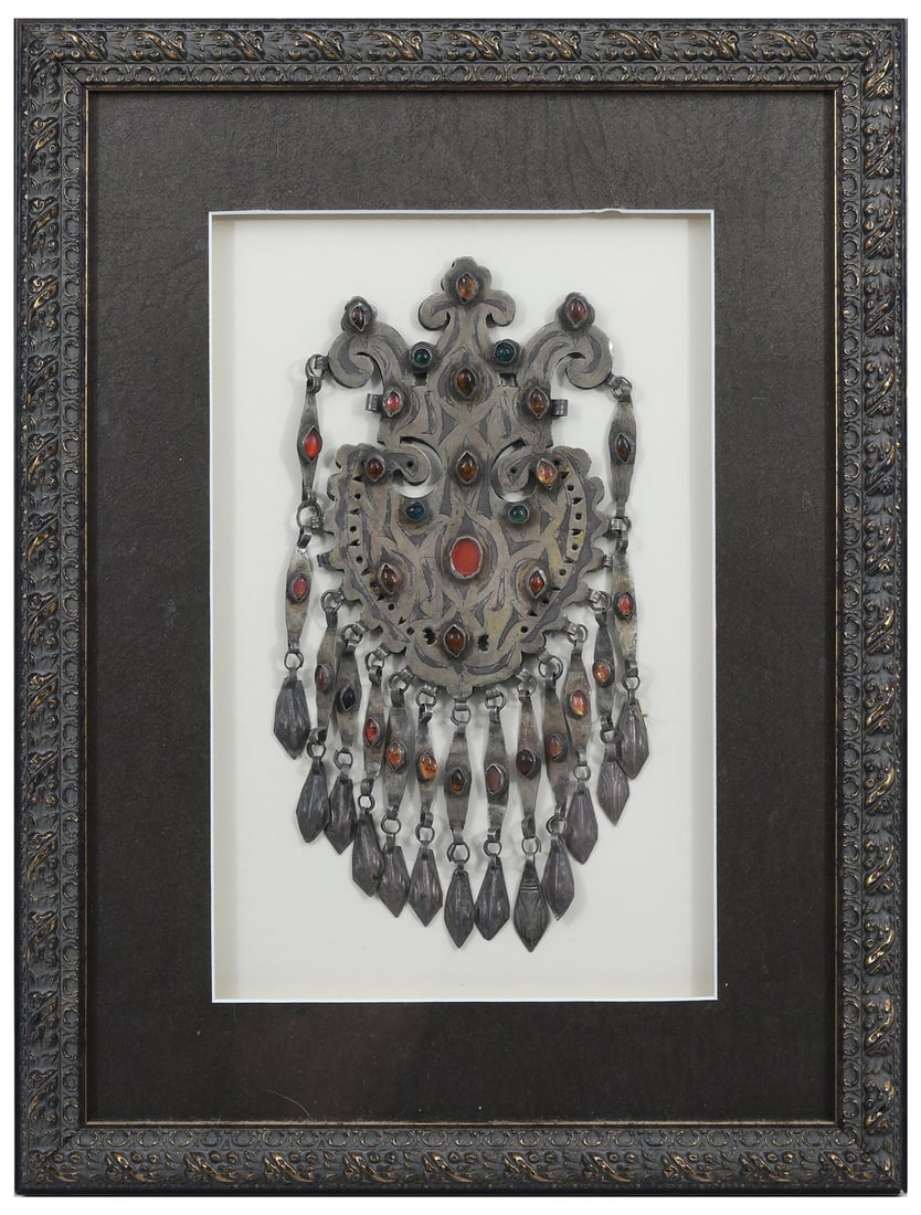 FRAMED SILVER TURKMEN PECTORAL ORNAMENT: FRAMED SILVER TURKMEN PECTORAL ORNAMENT: Turkmen low grade silver pectoral ornament, late 19th - early 20th-century, adorned by inset cabochon Amber, Carnelian & Glass. Approx. 9.75" h x 5.5" w. Frame