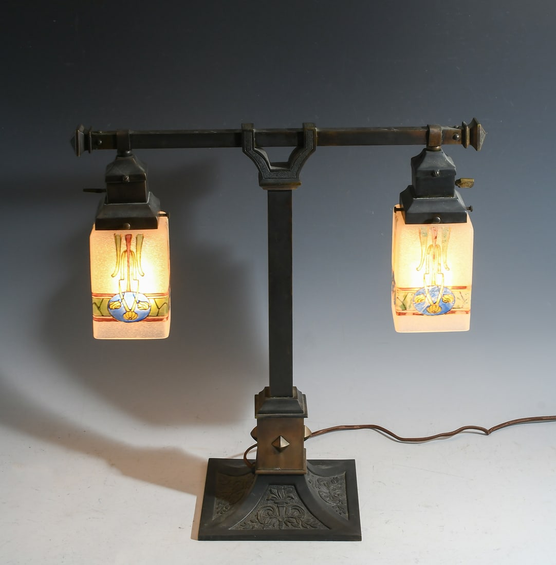 CZECHOSLOVAKIAN ARTS & CRAFTS DESK LAMP: CZECHOSLOVAKIAN ARTS & CRAFTS DESK LAMP: 2- Light Czechoslovakian Lamp with square textured glass shades with Art Nouveau enameled decoration, on a Bronze base. Approx. 17" h x 16.875" w x 6.75" d.