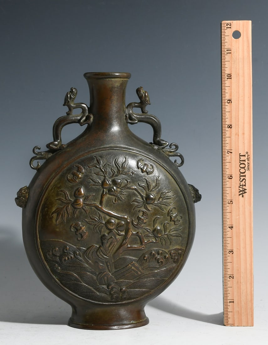 CHINESE BRONZE 9 PEACH MOON FLASK VASE: CHINESE BRONZE 9 PEACH MOON FLASK VASE: Chinese Bronze Moon Flask vase, having an Auspicious 9- Peach motif with Bats and stylized Water. Underside bears a raised stamp. Approx. 10.25" h x 7.75" w x 3