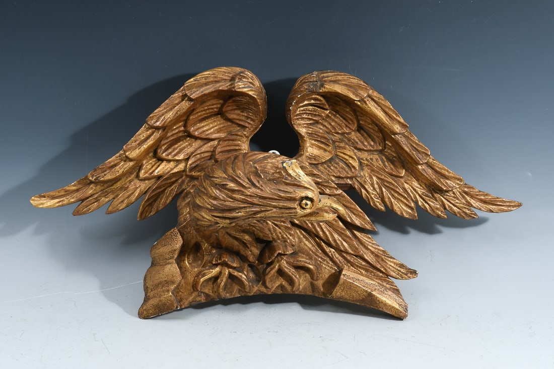 19TH-CENTURY CARVED GILTWOOD EAGLE CREST: 19TH-CENTURY CARVED GILTWOOD EAGLE CREST: 19th-Century Carved & Gilt stylized Eagle. Based on the verso, it appears to have been a surmounting piece, probably from a mirror. Approx. 12" h x 23.75" w x