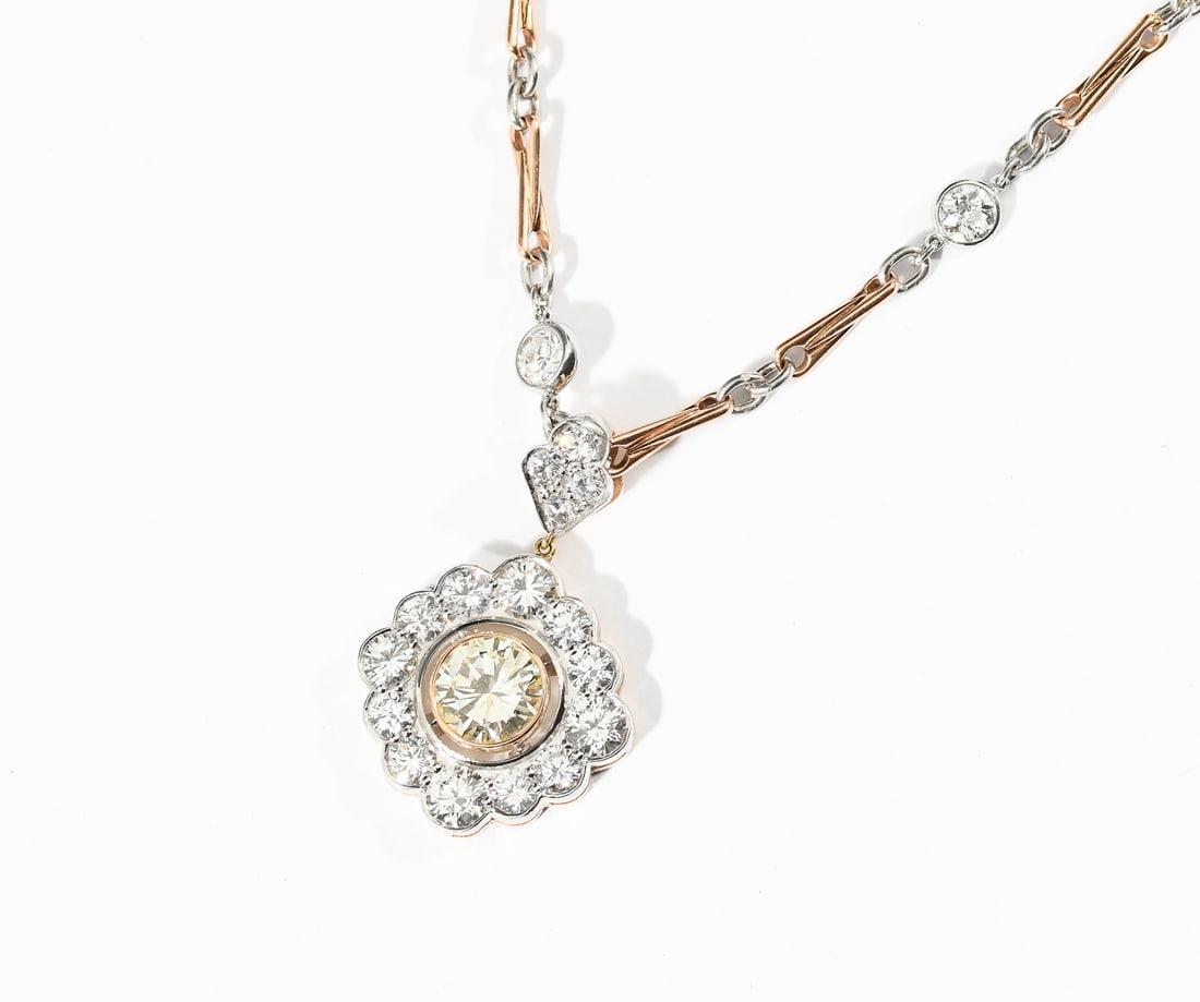 18K/14K/PLATINUM VINTAGE DIAMOND NECKLACE: 18K/14K/PLATINUM VINTAGE DIAMOND NECKLACE: 18K/14K two tone gold and platinum diamond necklace contains a 1.49 Ct. approximate, light yellow center stone. Rated SI2 and R-S in color. 30 round old Euro