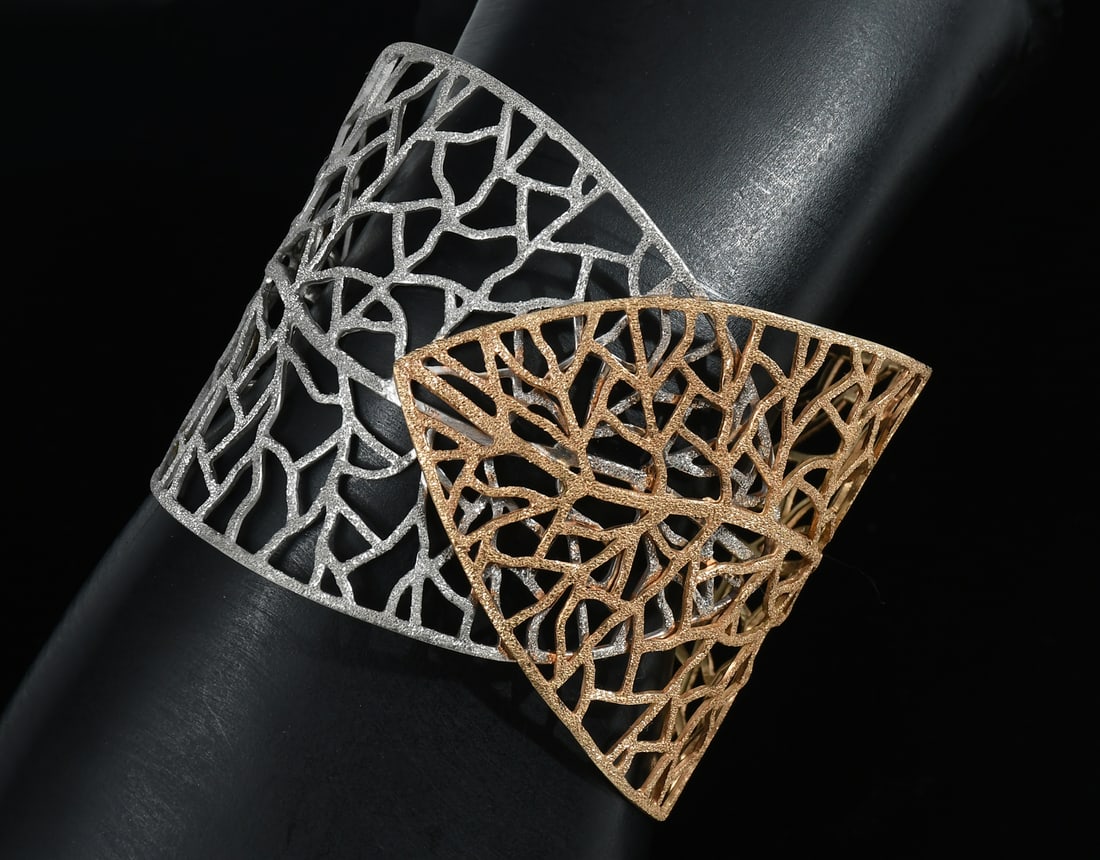 14K TWO TONE GOLD STYLIZED FOLIATE CUFF BRACELET: 14K TWO TONE GOLD STYLIZED FOLIATE CUFF BRACELET: 14K two tone gold lacey leaf cuff bracelet. Width: 2.25? at widest. Adjustable size. Weight: 38.0 grams.