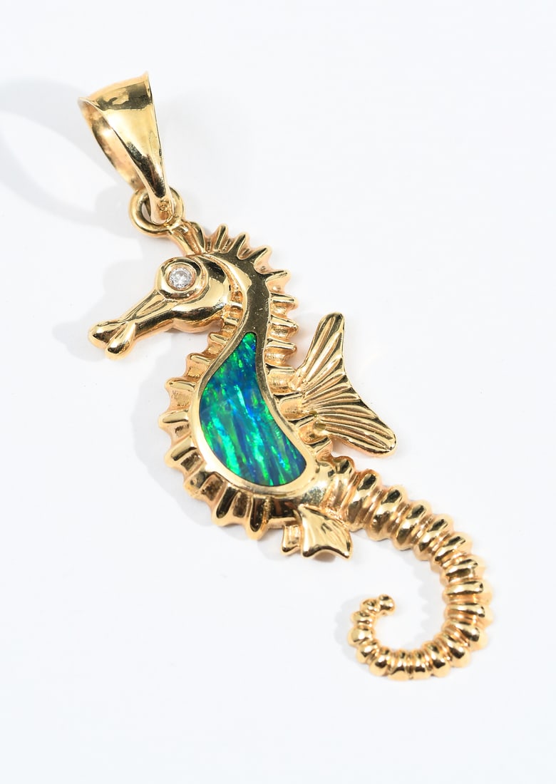 14K OPAL DOUBLET SEAHORSE PENDANT: 14K OPAL DOUBLET SEAHORSE PENDANT: 14K yellow gold seahorse pendant contains a freeform shaped inlaid opal doublet. One round brilliant cut diamond. WEIGHT: .025 Ct. Approx. Rated SI in clarity and