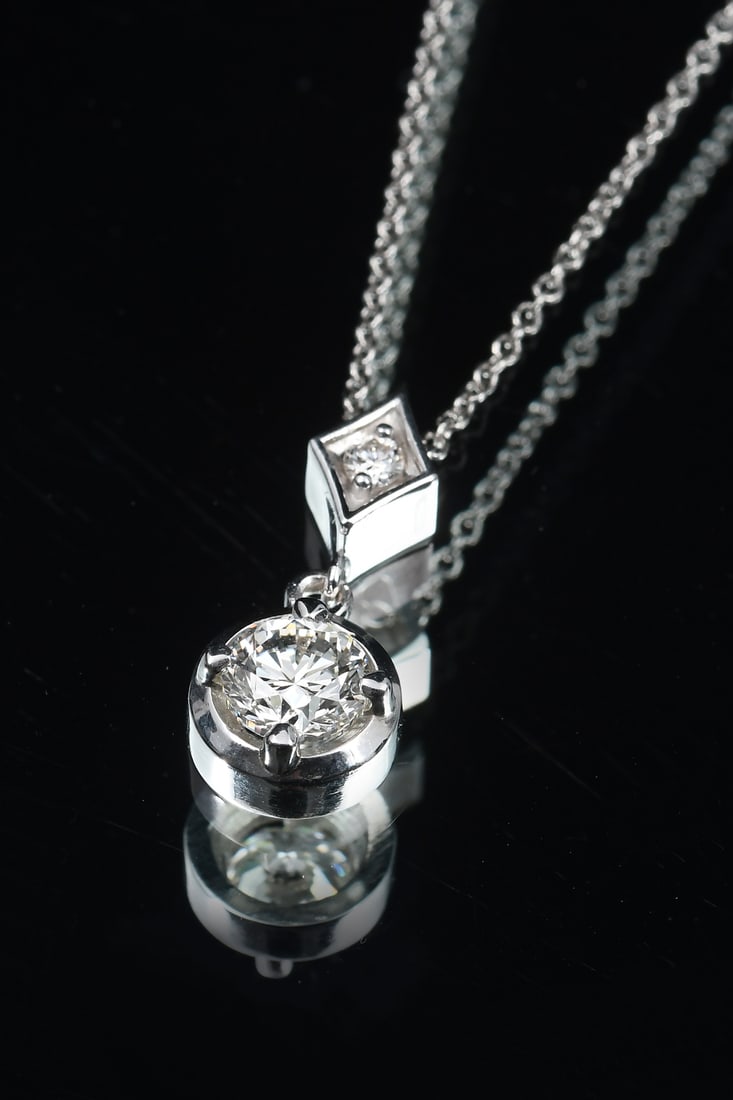 PLATINUM DIAMOND SOLITAIRE PENDANT: PLATINUM DIAMOND SOLITAIRE PENDANT: Platinum diamond pendant contains 1 round brilliant cut diamond. Weight .70 Ct. approximate. Rated VS1 in clarity and K in color. 1 Round brilliant cut diamond.