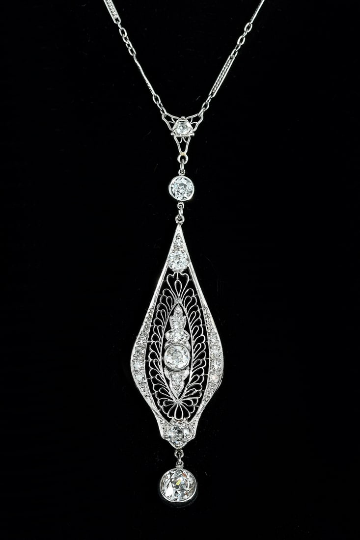 ANTIQUE PLATINUM FILIGREE DIAMOND LAVALIER: ANTIQUE PLATINUM FILIGREE DIAMOND LAVALIER: Antique platinum filigree diamond lavaliere necklace contains 1 old mine cut diamond. Weight: .95 Ct. approximately. Rated VS2 in clarity and G-H in color.
