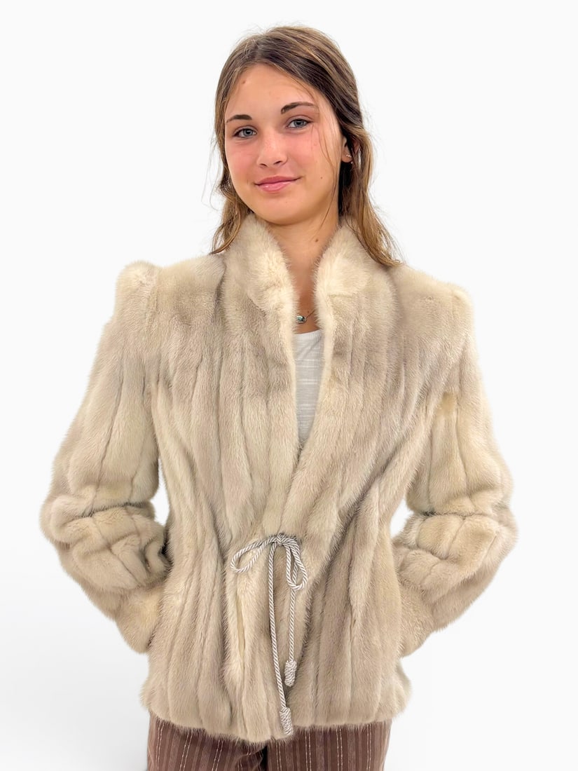 MINK CINCH WAIST JACKET: MINK CINCH WAIST JACKET: This luxurious mink cinch waist jacket is created of silver ribbed mink with stand up collar and banded cuffs. The off white/silver satin lining has an ornate embroidered desi