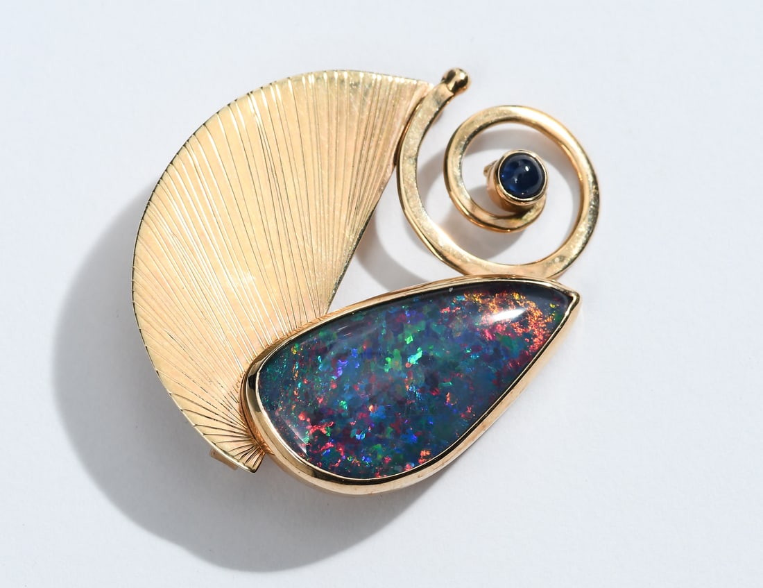 14K OPAL TRIPLET SIGNED MODERNIST BROOCH/PENDANT: 14K OPAL TRIPLET SIGNED MODERNIST BROOCH/PENDANT: 14K custom made Modernist brooch/pendant contains one 25.00 x 14.00 mm freeform opal triplet and one 3.00 mm cabochon cut sapphire. The opal and sapph