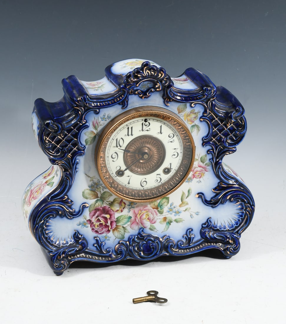 ANSONIA DRESDEN EXTRA PORCELAIN CASE CLOCK: ANSONIA DRESDEN EXTRA PORCELAIN CASE CLOCK: Cobalt and floral decor with gilt accents. 8 day cathedral bell strike, key wind. Manufactured ''expressly for the American Wringer Co.". No. 89. Hinged bra