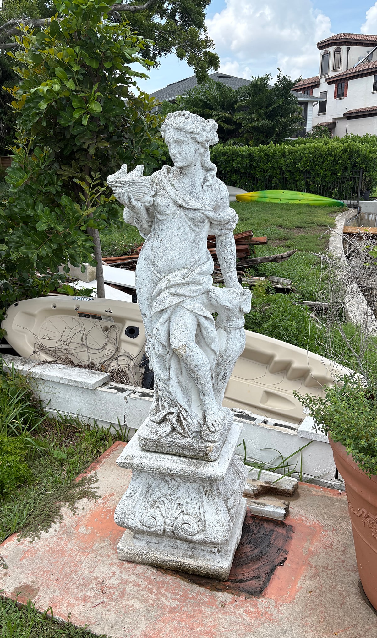 GODDESS CEMENT GARDEN STATUE WITH PEDESTAL BASE: GODDESS CEMENT GARDEN STATUE WITH PEDESTAL BASE: Tall nature goddess garden statue with short column plinth. Statue stands 50" in height, measures 69.5" in height overall when placed on the plinth.