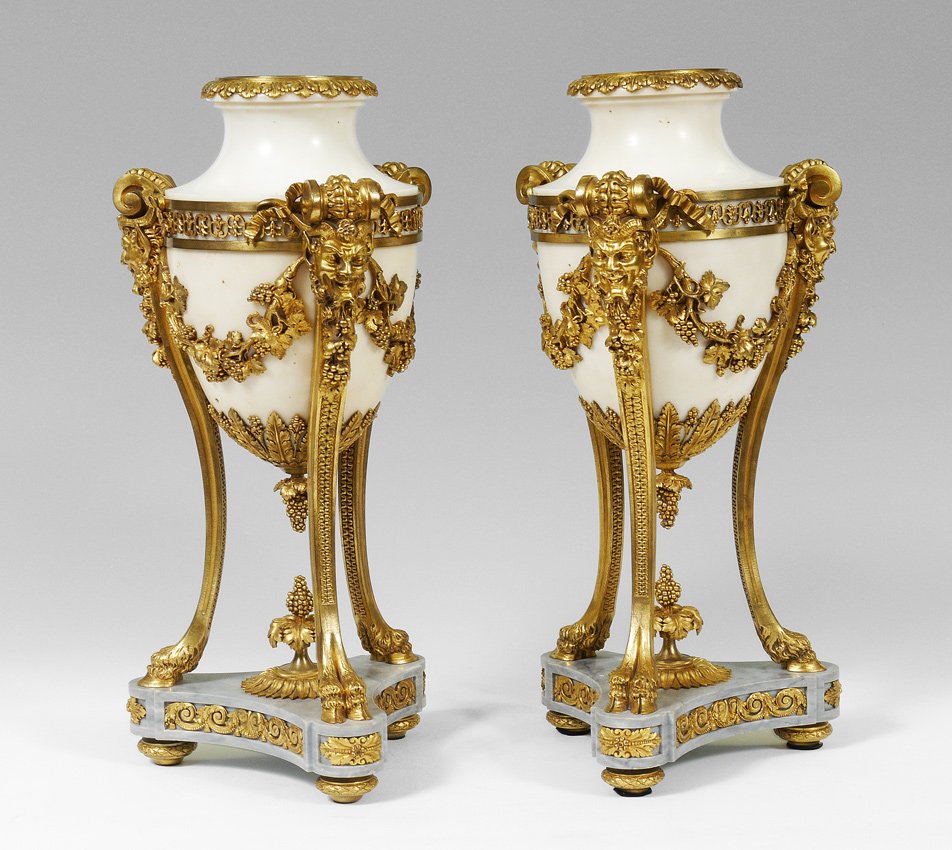 PAIR 19TH CENTURY FRENCH BRONZE DORE MARBLE URNS: PAIR 19TH CENTURY FRENCH BRONZE DORE MARBLE URNS: Bronze dore mounted with filigree, satyr masquerons, grape vines, and hoofed feet ending at marble base. White marble body with inserts. Overall 18 3/
