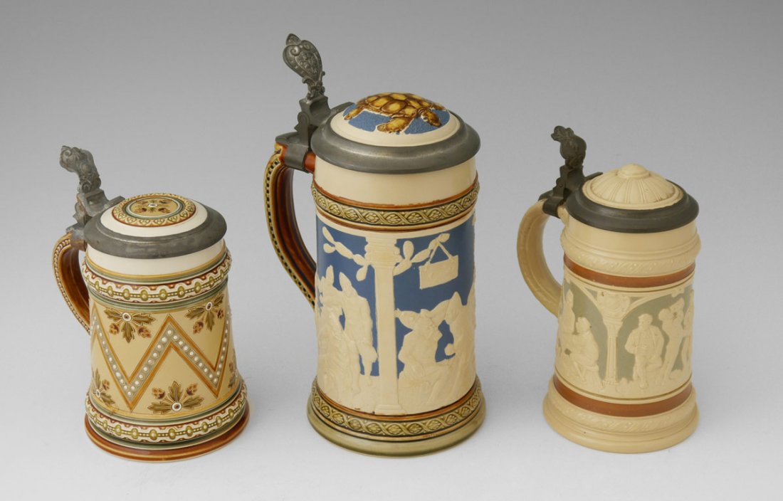 COLLECTION OF 3 METTLACH STEINS: COLLECTION OF 3 METTLACH STEINS: 3 steins total to include 1) #2249, 3 panels of drinking scenes. 3/10 liter, 1897, 6 1/4" h. x 4 1/2". 2) #1788, geometric designs. 3/10 liter, 1892, 6" h. x 4 3/4". 3