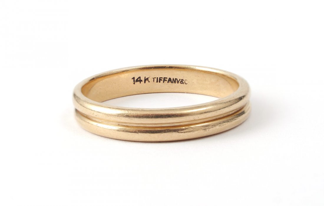 TIFFANY & CO 14K GOLD WEDDING BAND RING SZ 10.5: 14K TIFFANY & CO WEDDING BAND RING: 14K yellow gold wedding band. Signed: Tiffany & co. 4.25 mm wide. Weight: 4.8 grams. Size: 10.5