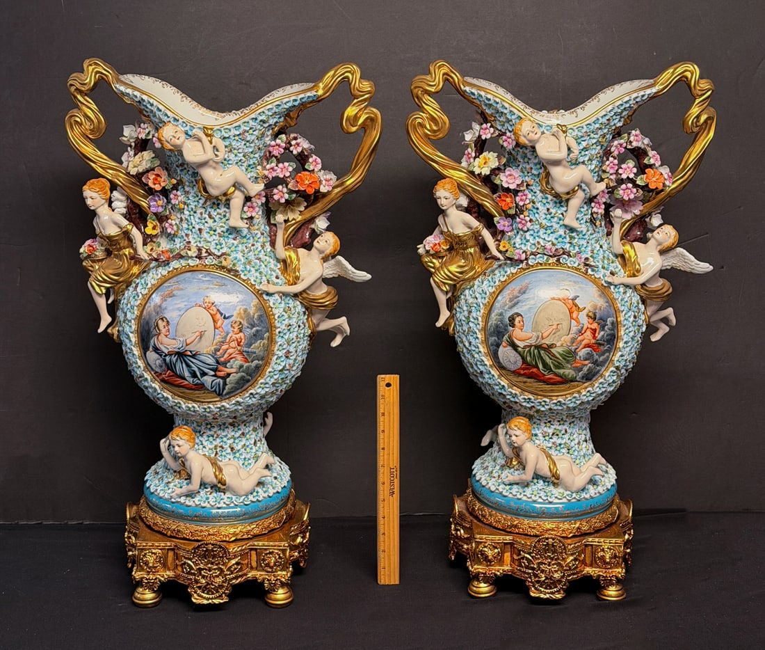 SET OF RICHARD KLEMM DRESDEN HANDLED VASES: SET OF RICHARD KLEMM DRESDEN HANDLED VASES: Pair of Large German Richard Klemm Porcelain vases, having numerous attached Flowers and Classical Cherubic scenes with Female artists. All adorned by Angel