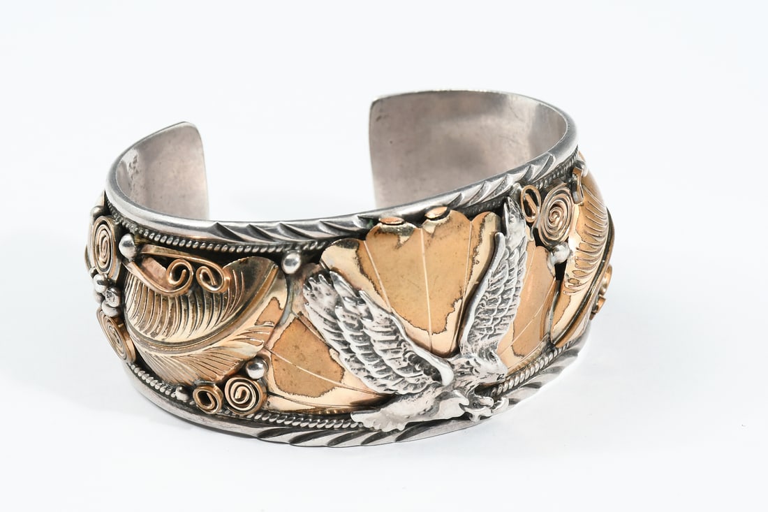 ALLEN CHEE SIGNED SOUTHWEST STERLING CUFF: ALLEN CHEE SIGNED SOUTHWEST STERLING CUFF: Large Southwest sterling cuff signed by Allen Chee. Crafted with sterling and 12K gold fill or vermeil accents, featuring a central soaring eagle over a sunb