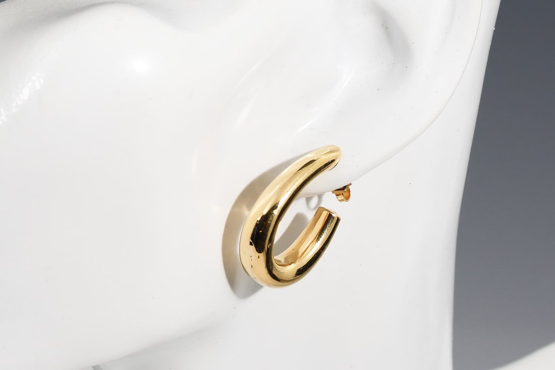18K TIFFANY CUSHION HOOP EARRINGS: 18K TIFFANY CUSHION HOOP EARRINGS: 18K Yellow gold cushion hoop earrings by Tiffany & Co. Marked 750 T&Co. Clutch backs, one marked "750 T&CO" and the other marked "1/20 14K". Sold with a blue velvete