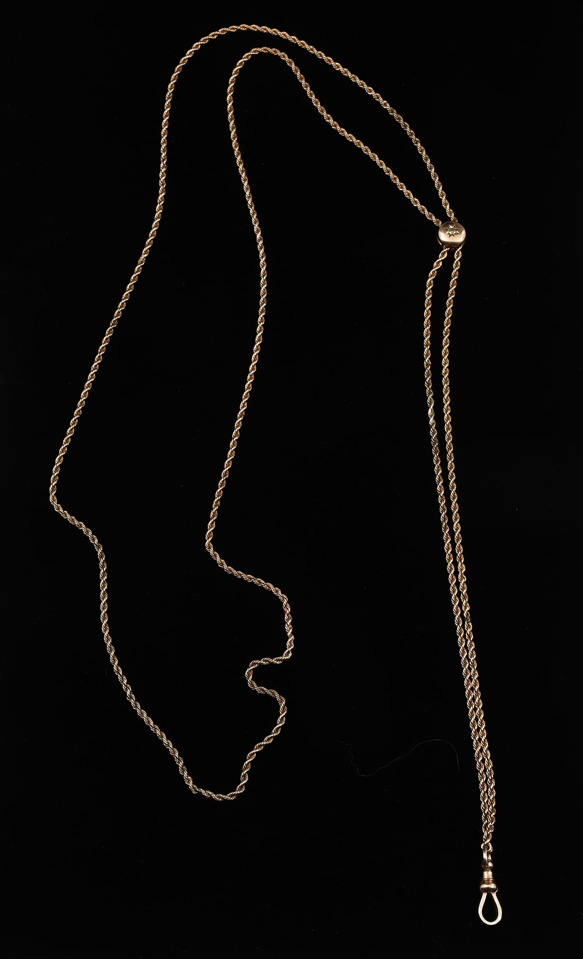10K GOLD VINTAGE SLIDE CHAIN: 10K GOLD VINTAGE SLIDE CHAIN: A 10K yellow gold rope slide chain accented with a 0.05 Ct old mine cut diamond. Length: approximately 48". Weight: 24.4 grams.