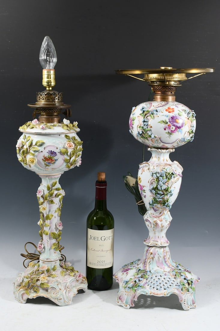 2 TALL GERMAN PORCELAIN FLORAL BANQUET LAMPS: 2 TALL GERMAN PORCELAIN FLORAL BANQUET LAMPS: Two Dresden Porcelain Banquet Lamps with hand-painted Floral windows and attached Flowers. Both bear blue stamps at the undersides. Largest approx. 24" h 