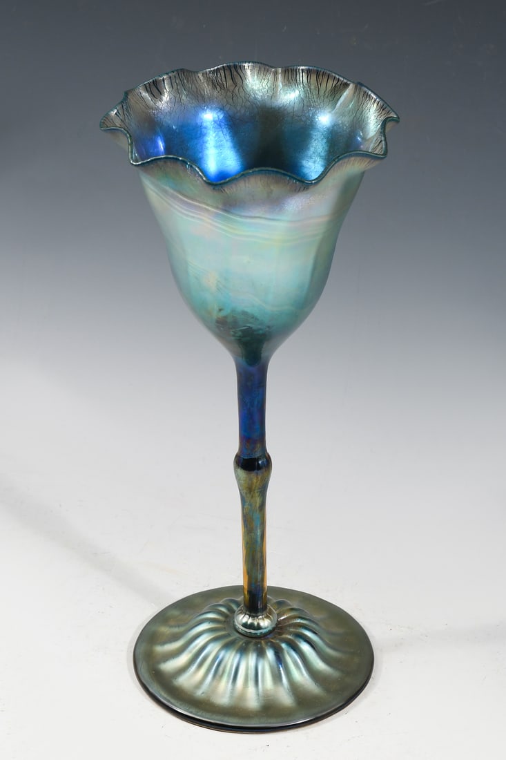 LARGE LUNDBERG STUDIO ART GLASS CHALICE: LARGE LUNDBERG STUDIO ART GLASS CHALICE: Large Blue Iridescent Floriform Art Glass Chalice. Etched signature, 1983. Approx. 13" h x 5.75" dia.