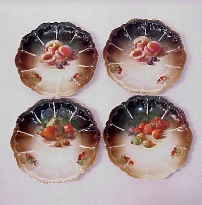 SET OF 4 AUSTRIAN FRUIT PLATES 1894-1909: SET OF FOUR AUSTRIAN FRUIT PLATES: Ca. 1884-1909, Moritz Zdekauer. Fine porcelain scalloped rim plates, each decorated in a fruit motif. 9" dia. Hairline crack visible only to the back of one.