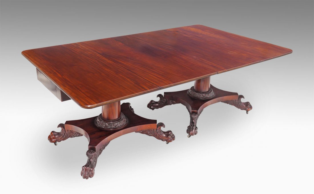 PERIOD EMPIRE DOUBLE PEDESTAL MAHOGANY TABLE: PERIOD EMPIRE 2 PART DOUBLE PEDESTAL MAHOGANY BANQUET TABLE: Richly grained tops, carved apron. Each pedestal a free standing drop leaf table on raised plinth with carved paw feet and castors. May be