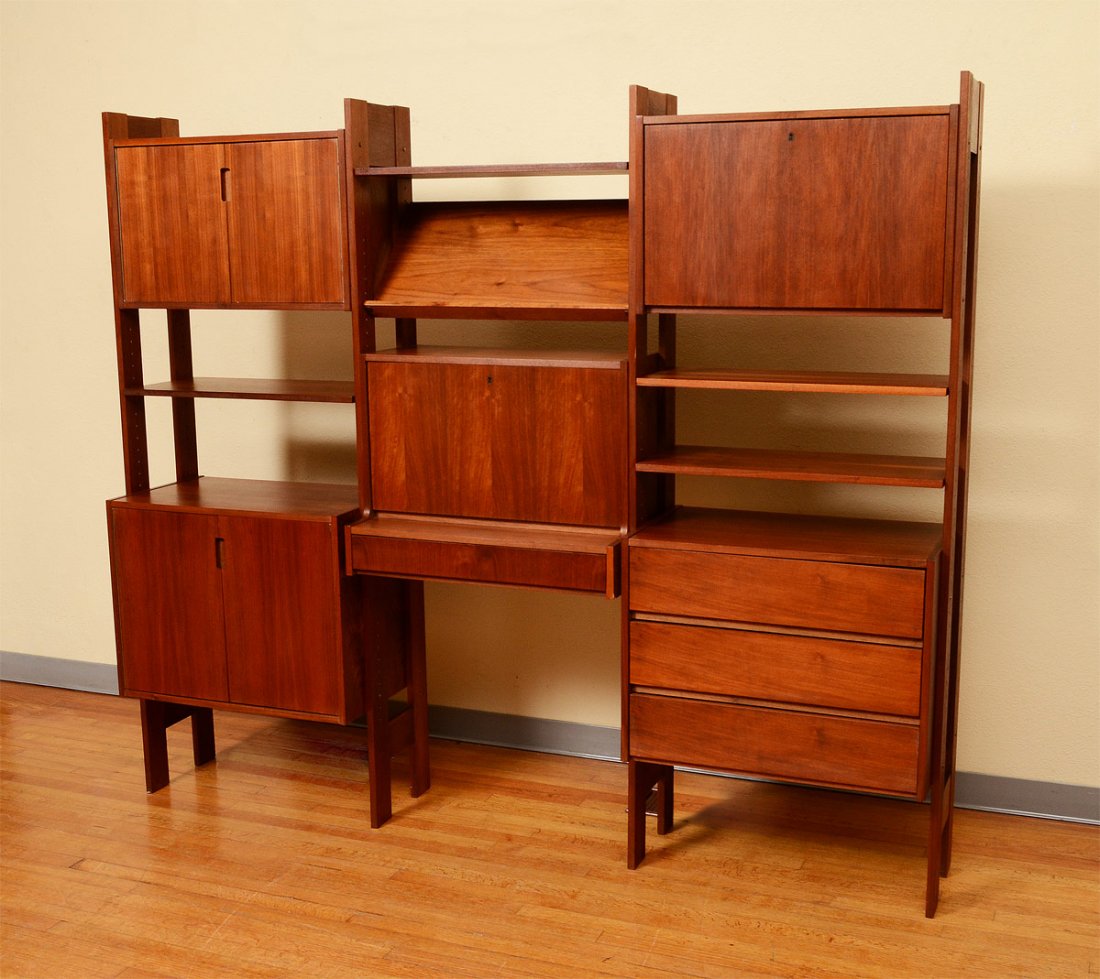 MID CENTURY TEAK WALL STORAGE UNIT: MID CENTURY TEAK WALL STORAGE UNIT: Modular system with 3 sections. Individual units comprise of 2 door with single shelf, larger 2 door with single shelf, magazine rack, drop front secretary with dra