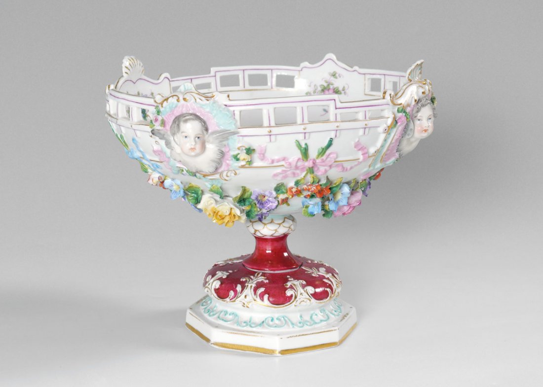 18TH CENTURY VOLKSTEDT COMPOTE: 18TH CENTURY VOLKSTEDT COMPOTE: Reticulated rim with cherub masquerons, applied floral decoration. Base marked with late 18th century Volkstedt pitchfork mark. Measures 6 3/4'' h. x 8''.
