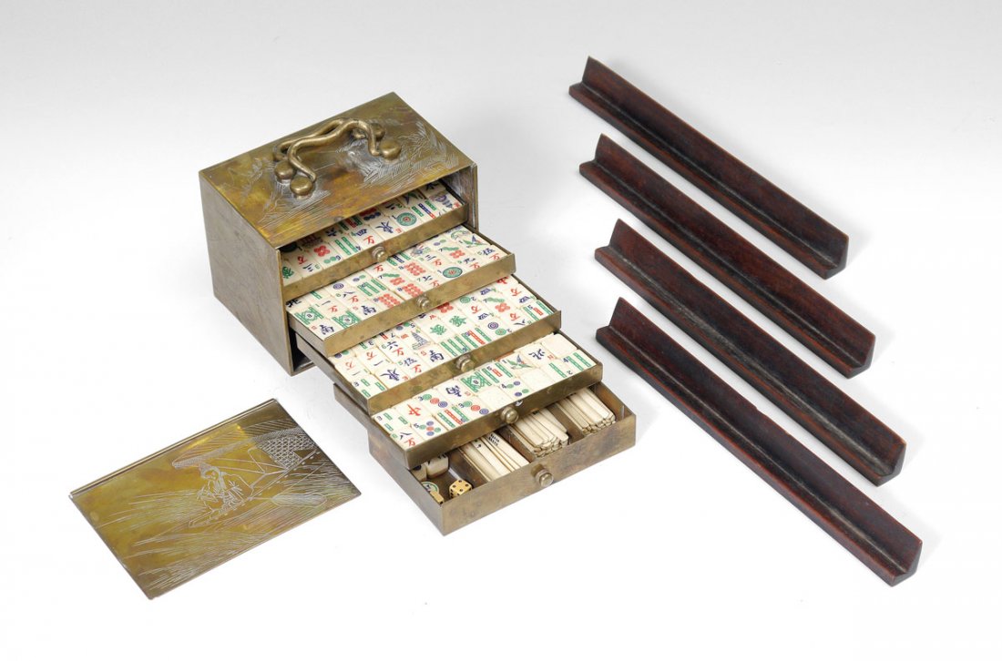 ENGRAVED BRASS CASE MAHJONG SET: ENGRAVED BRASS CASE MAHJONG SET: 148 bone and bamboo mahjong pieces with dice and betting sticks. Comes in brass case with engraved oriental motifs and 5 trays. Overall case measures 4" x 5 1/2" x 3 1