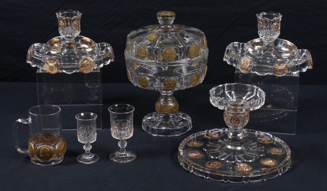 EAPG COLUMBIAN EXPO COIN GLASS 7 PC: 7 PIECE EAPG 1892 COLUMBIAN EXPOSITION COIN GLASS: To include 2 stem glasses (4 & 4 1/2), covered compote (12"), cake stand (6 /2" x 10"), handled mug, and pair of what may be smoke stands.