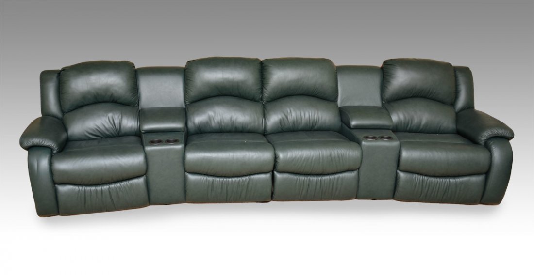 DAKOTA LEATHER HOME THEATER SYSTEM: DAKOTA LEATHER HOME THEATER SEATING: 4 recliners and 2 sections for drink holders make up the 6 section spruce green leather sectional sofa. Measures approx. 12 ft. Original purchase price, $4000.00