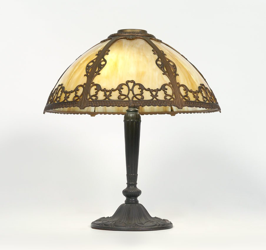 PITTSBURGH 6 BENT PANEL SLAG GLASS LAMP: PITTSBURGH 6 BENT PANEL SLAG GLASS LAMP: Pittsburgh heavy cast metal base, 2 socket fixture, 19 1/4" h. x 7 3/4". Shade with filigree gilt metal frame, 6 bent caramel slag glass panels, 7 3/4" h. x 17