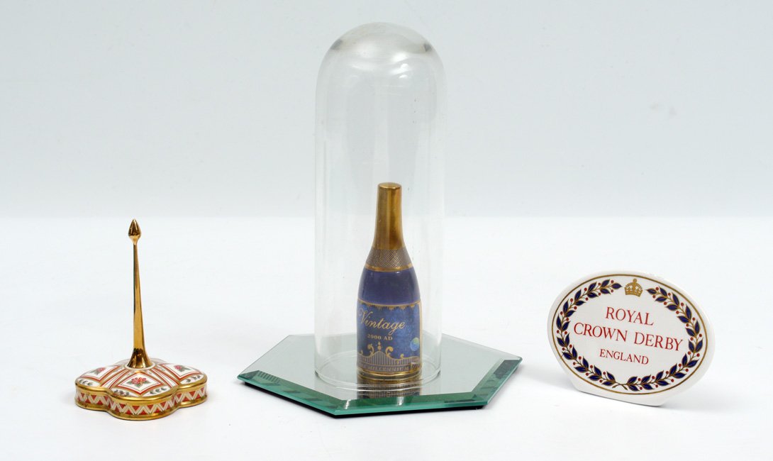 CROWN DERBY RING HOLDER & WORCESTER MILLENNIUM: 3 PIECE ENGLISH BONE CHINA NOVELTIES: 1) Royal Crown Derby Honeysuckle ring older, 4 1/4", 2) Royal Crown Derby trade sign, 3" x 4 1/4". 3) Royal Worcester 4 1/4" bone china bottle celebrating the Mil