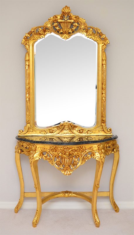 MARBLE TOP GILT FOYER TABLE AND MIRROR: MARBLE TOP GILT FOYER TABLE AND MIRROR: 2 pieces to include 1) Foyer table with shaped varigated marble top on gilt shaped, pierced and carved base. 34" h. x 45" x 16 1/2". 2) Ornate gilt wood beveled