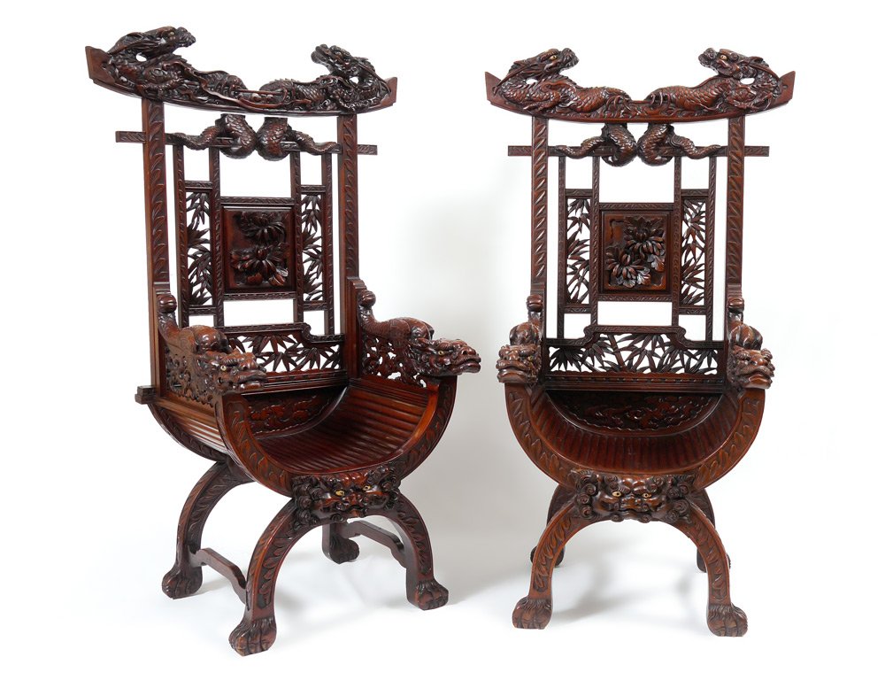 PAIR PROFUSELY CARVED ORIENTAL DRAGON CHAIRS: PAIR PROFUSELY CARVED ORIENTAL DRAGON CHAIRS: Carved all over with full figural dragons at top crest and arms. Back with foliate and floral motifs, shaped fluted seat. Front with masqueron under seat,