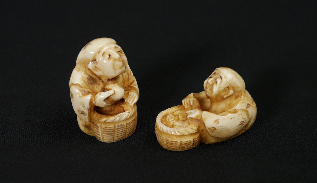 2 CARVED IVORY NETSUKES: 2 CARVED IVORY NETSUKES: 2 pieces to include 1) Seated man with basket and fruit, signed, 1 1/2" h. 2) Seated man with basket, signed, 1 3/4" long.