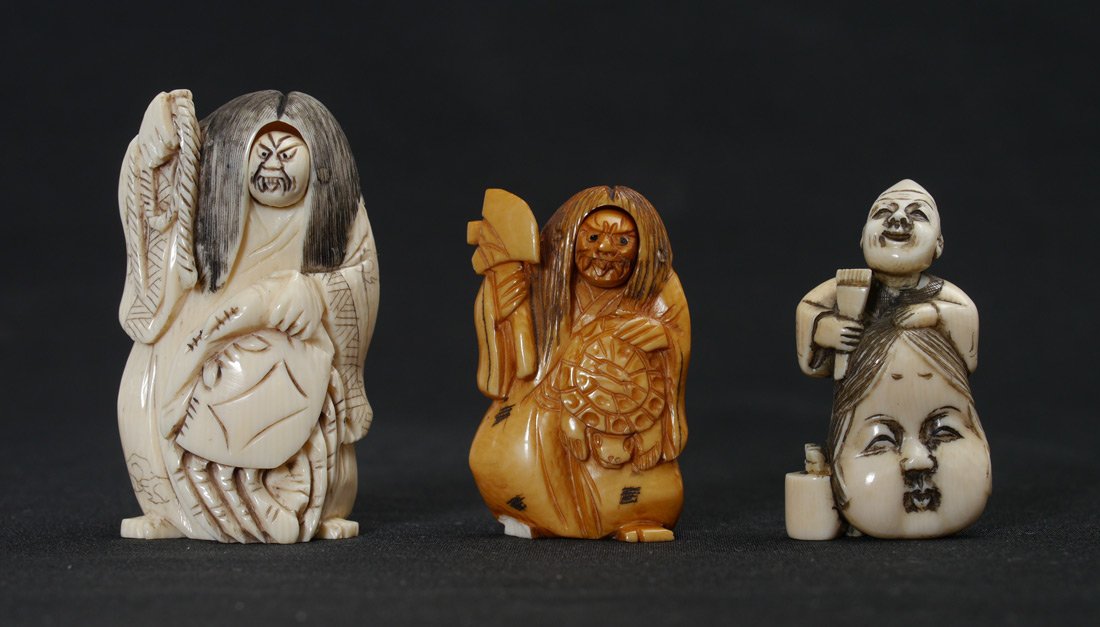 3 PIECE ARTICULATED CARVED IVORY NETSUKES: 3 PIECE ARTICULATED CARVED IVORY NETSUKES: To include 1) Man standing behind large mask with moving head. Signed, 2'' 2) Man holding hatchet with articulated double face, note chip on foot. Signed, 2'