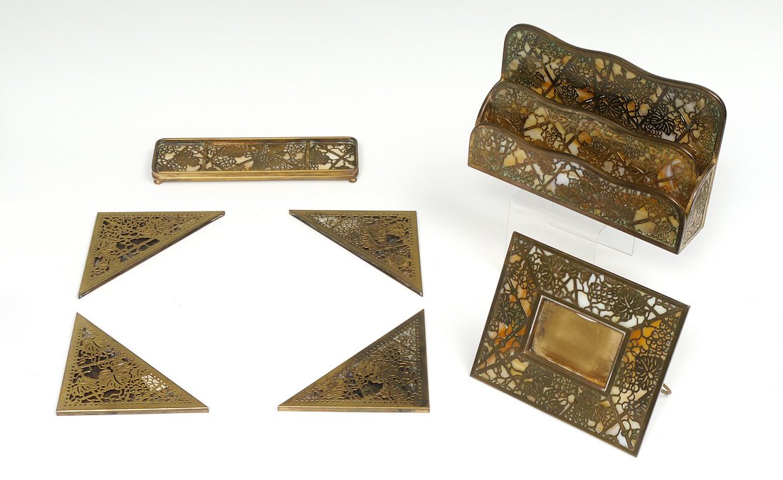 7 PIECE TIFFANY STUDIOS GRAPEVINE DESK SET: 7 PIECE TIFFANY STUDIOS GRAPEVINE DESK SET: 7 pieces total in the Grapevine pattern by Tiffany Studios with caramel slag glass inserts where appropriate to include 1) Double letter tray, 1003, 6 1/8''