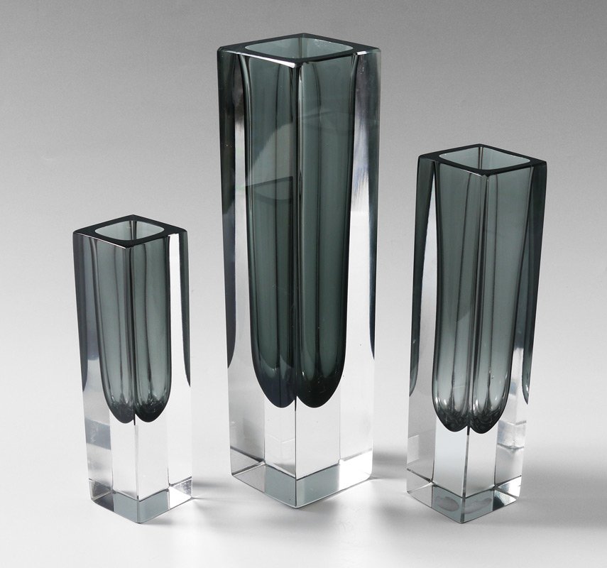 SET OF 3 MURANO ART GLASS VASES: SET OF 3 MURANO ART GLASS VASES: All formed in clear to smoke crystal, in tall-shaft design with three graduated sizes, bear original factory labels. Tallest 10\" h. x 2 1/2\" square.